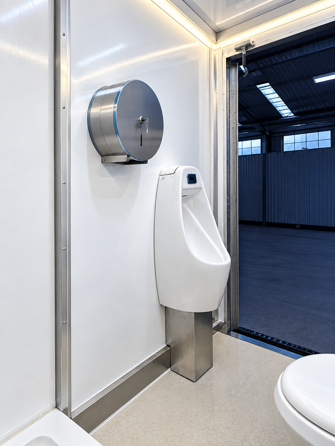 Urinal and sink inside a temporary restroom trailer